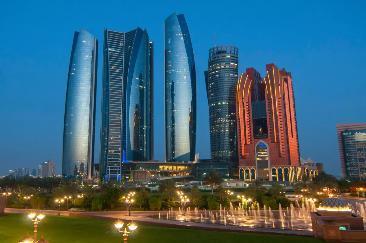 Abu Dhabi towers at night, home to the ADGM fund managers regulated by the FSRA