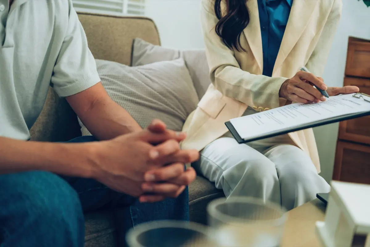 An adviser explaining structuring documents to clients weighing a DIFC or ADGM family office