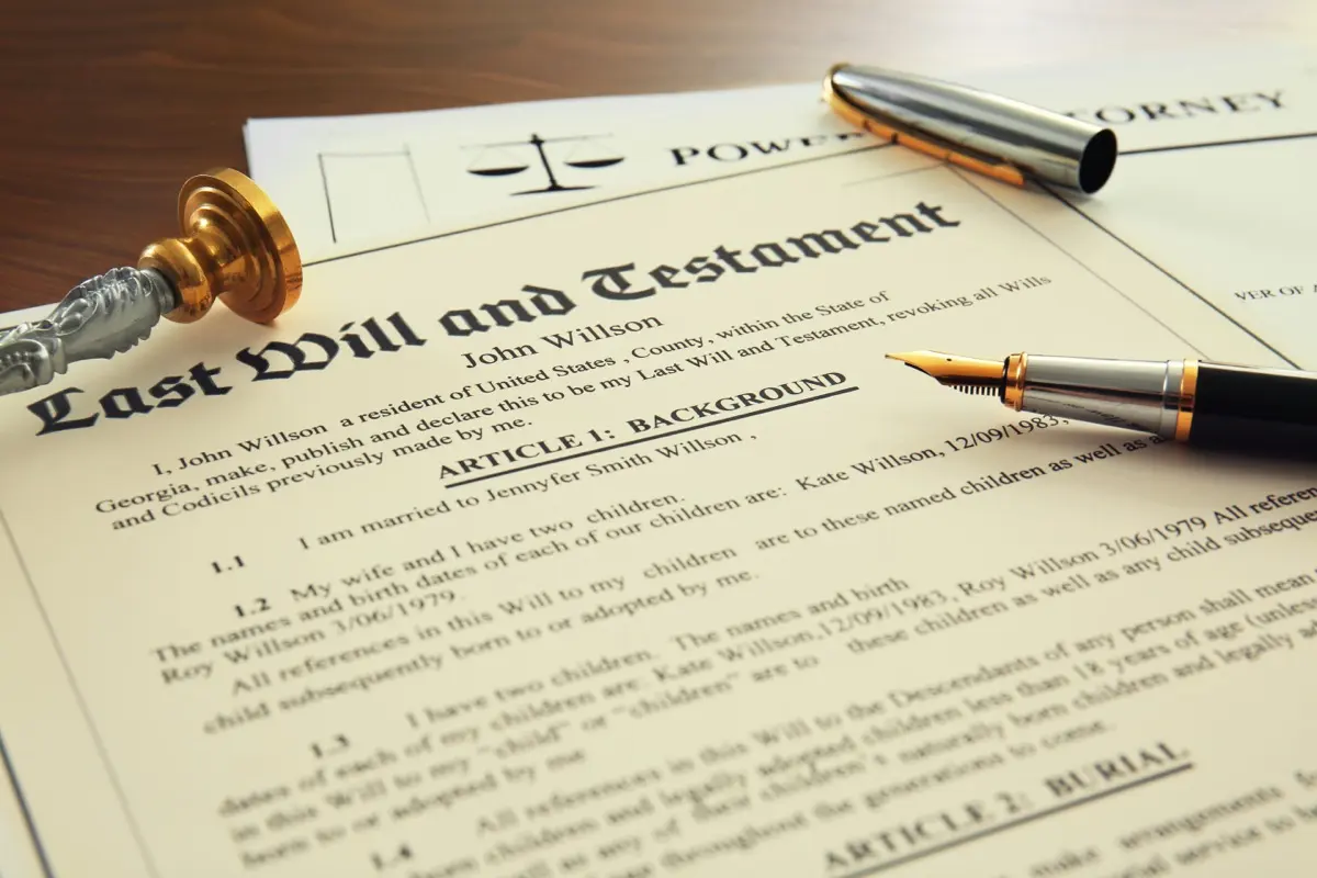 A pen, stamp and signed documents on a notary's desk, where wills, gifts and foundation charters are formalised