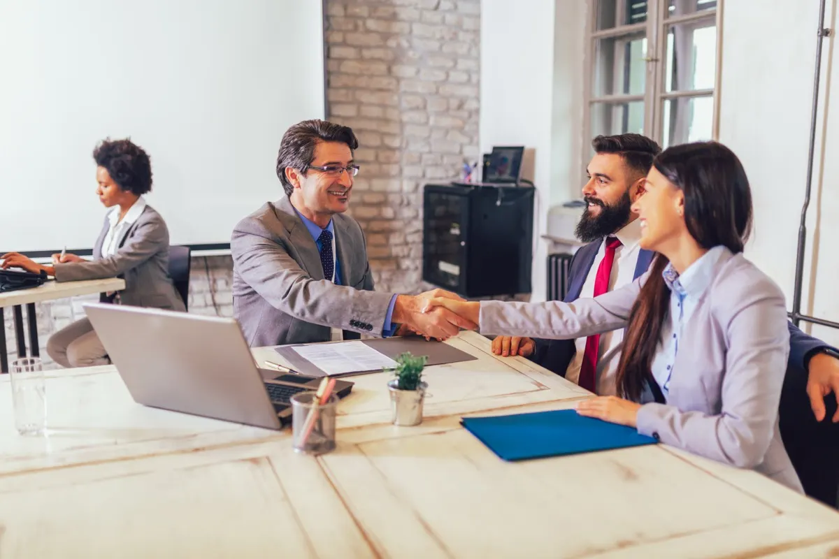 A newly arrived couple opening a personal UAE bank account with a relationship manager, the step that starts the six months of statements a tax residency certificate application relies on.