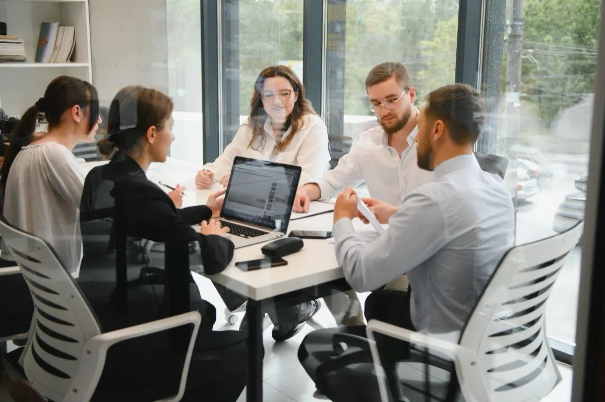 An advisory meeting in Dubai reviewing a new resident's visa, Emirates ID and tenancy documents ahead of a UAE tax residency certificate application.