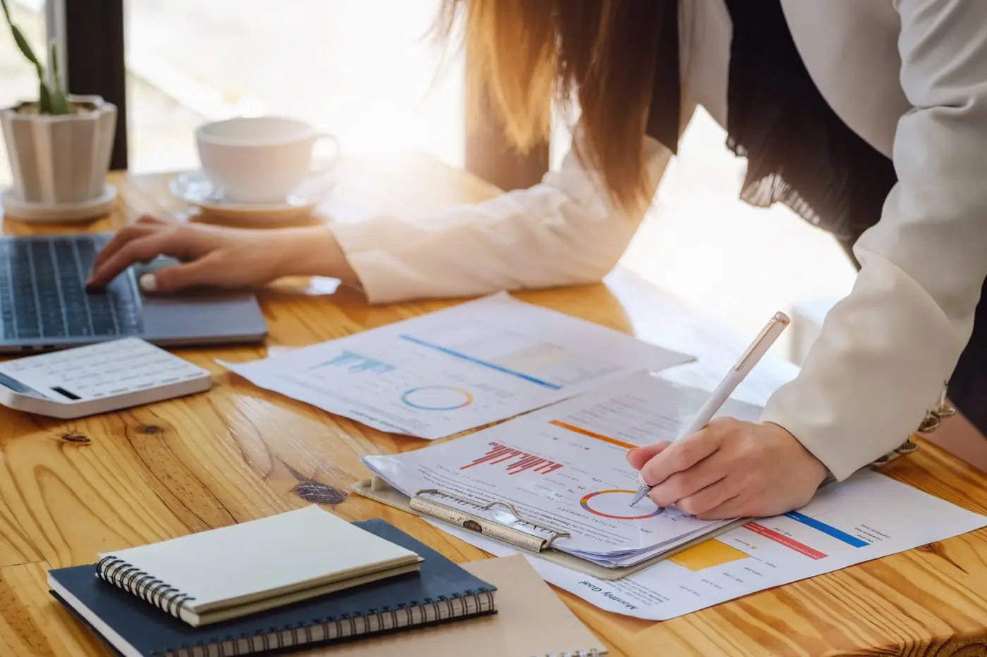 An adviser marking up risk assessments and financial charts at a desk, the work investors did before committing capital this year