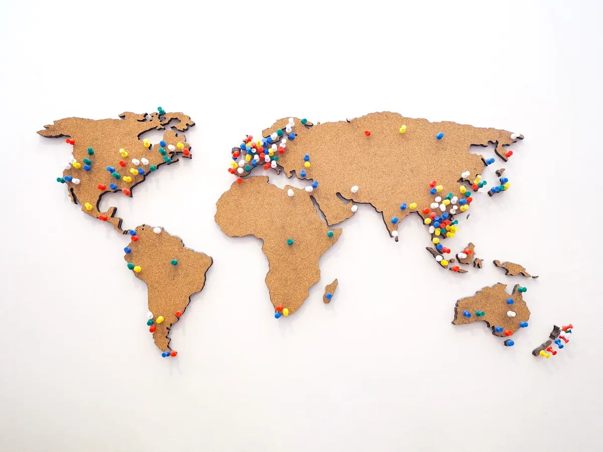 Pins marking locations on a world map, representing the country by country differences in setting up a UAE structure